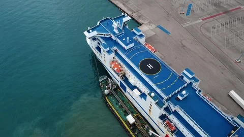 Side View of Ferry Ship with Helipad and Supply Tanker at Harbor Pier Stock Footage 343995653