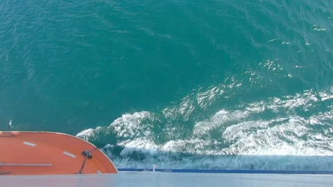 Side view from a ferry showing part of a life boat and the spray of the ship Stock Footage 182364420