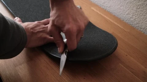 Side view of finishing a skateboard - griptape process Stock Footage 306570288