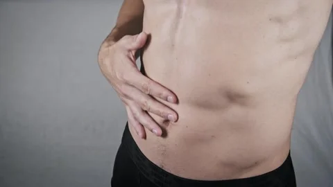 Side View of a Fit Man Touching His Abdominal Side Stock Footage 316418233