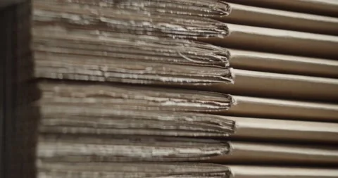Side View Of A Flatpack Parcel Cardboard Box Stacked In A Pile - downward Stock Footage 136121658