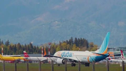Side view of Flydubai passenger airplane taking off Stock Footage 201922382