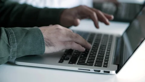 Side view of focused developer in eyeglasses working with laptop Stock Footage 121402063