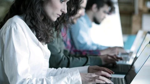 Side view of focused female developer working with laptop 動画素材 121401435