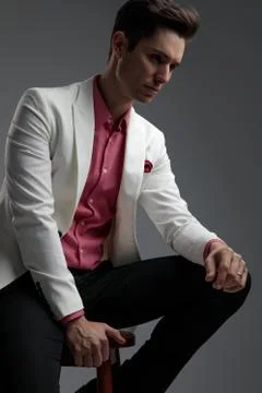 Side view of focused man resting his arm on knee Stock-Fotos