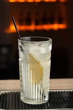 Side view on fresh cool cocktail gin tonic with a slice of pear and ice in .. Stock Photos