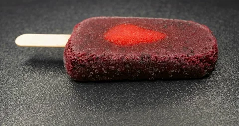 Side view fresh mulberry and blueberry flavor popsicle with slice of strawber Stock Footage 151754530