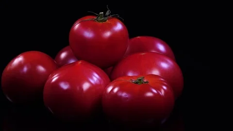 Side view of fresh pink tomatoes, apple of love, rotating against the clock Video stock 78355943