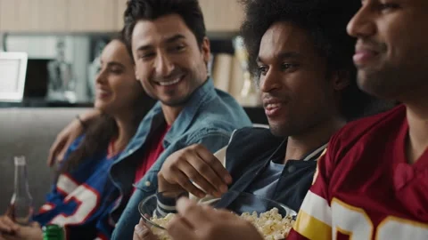 Side view of friends watching something funny in TV Stock-Footage 130996904