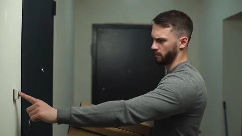 Side view of frustrated delivery man delivering boxes with pizza to client on Stock Footage 146637110