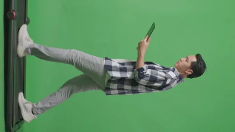 Side View Full Body Of Asian Man Using Tablet While Walking On Green Screen Stock Footage 248007407