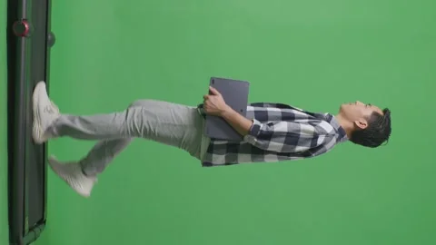 Side View Full Body Of Asian Man Holding Tablet While Walking On Green Screen Stock Footage 248007494