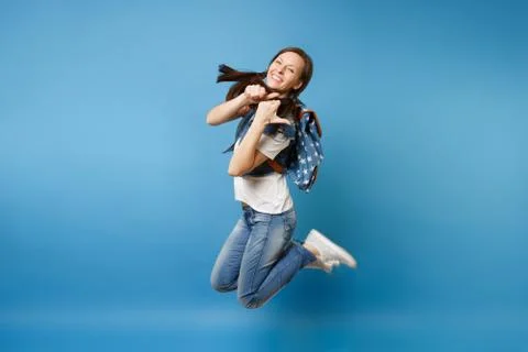 Side view Full length portrait of young laughing woman student in denim clothes Stock Photos