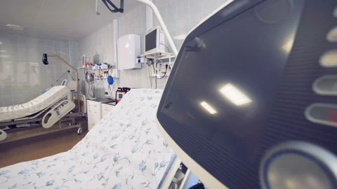 Side view of a fully-equipped hospital ward with a focus on a bed and a monitor Stock Footage 87471237