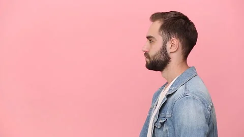 Side view fun guy 20s years old in denim jacket white t-shirt isolated on pastel Video stock 136324363