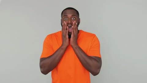 Side view fun young bearded african american guy 20s in orange basic t-shirt Stock Footage 148317927