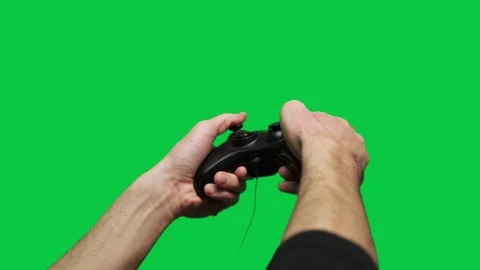 Side view of gamer playing game with controller, green screen Видео 111345350