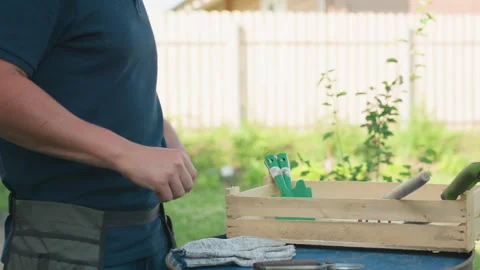 Side View Gardener Dropping Tools On Drum Dusting Hand By Crate Stock-Footage 318044923