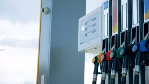 Side view of a gasoline pump with multicolour-handled pistols Stock Footage 101120467