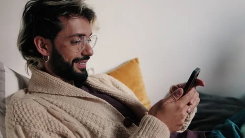 Side view of the gay or young man at Home Using Smartphone Stock Footage 304824068