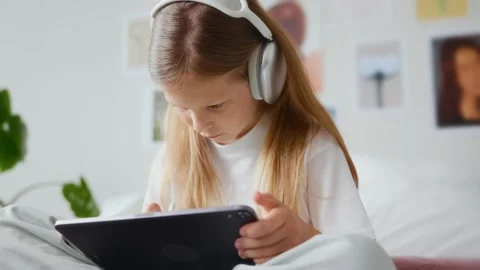 Side view of girl drawing on tablet with stylus Stock Footage 311918756