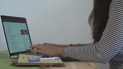 Side view of a girl typing on the macbook Stock Footage
