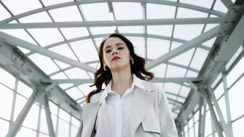 The side view of a girl walking in a light outfit against the background of Stock Footage 242600615