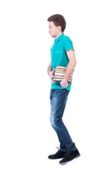 Side view going man carries a stack of books Foto stock