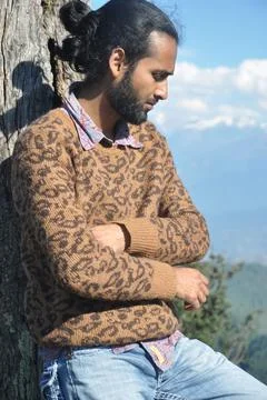 Side view of a good looking Indian young men with hair bun Stock Photos