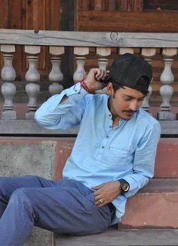 Side view of a good looking north Indian young guy touching his cap Stock Photos