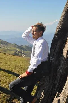Side view of a good looking young guy posing with moving his hand on hair  Stock-Fotos