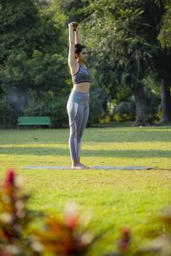 Side View of a Gorgeous Lady Doing the Palm Tree Pose Stock Photos