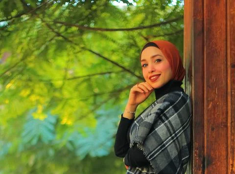 Side view of gorgeous middle eastern Muslim young woman posing for photo  Stock Photos