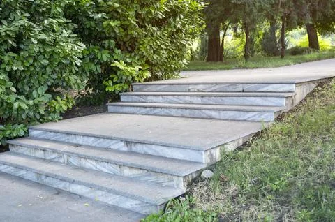 Side view of granite steps in a park urban zone. Detailed stone masonry and Stock Photos