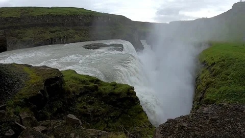 Side view of Gullfoss waterfall with tourist viewpoint and mist, Iceland Stock Footage 334871991