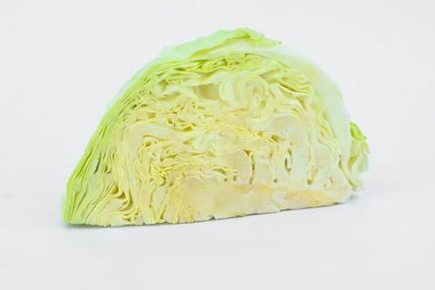 Side view of a half cut fresh green and white cabbage vegetable isolated in a Stock Photos