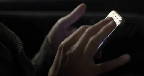 Side view of a hand of a girl texting on a slightly broken phone Stock Footage 217429260