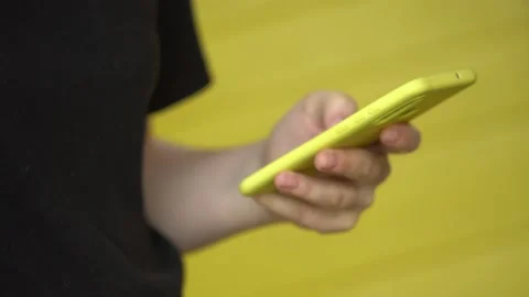 Side view. Hand of girl using smartphone, typing message. Close-up of young Stock Footage 132187723