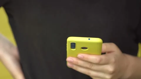 Side view. Hand of girl using smartphone, typing message. Close-up of young Video stock 132502732