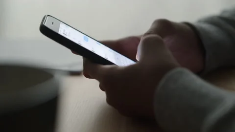 Side view. Hand of girl using smartphone at home, typing message. Stock Footage 132814821