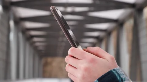 Side view. Hand of girl using smartphone in office, typing message. Close up of  Video stock 148903367