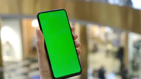 Side view. Hand of girl using smartphone with chroma key in the shopping center Stock Footage 151585352