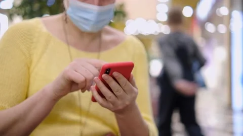Side view. Hand of girl using smartphone in the shopping center Stock Footage 154074328