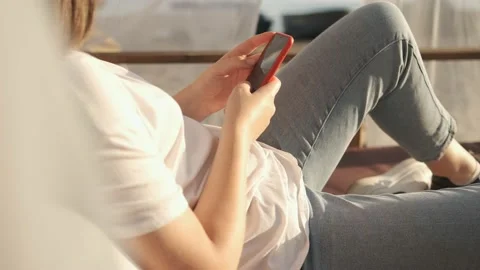 Side view. Hand of girl using smartphone on the terrace by the lake, typing Stock Footage 159456754