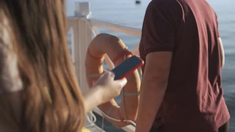 Side view. Hand of girl using smartphone on the terrace by the lake, typing Stock Footage 159928790