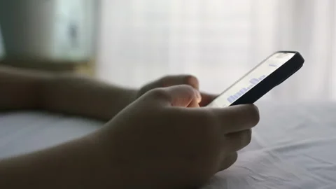 Side view. Hand of girl using smartphone at home night Stock Footage 165870643