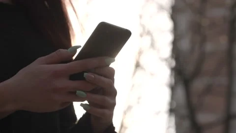 Side view. Hand of girl using smartphone outdoors Stock Footage 166499723