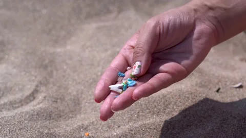 Side view of a hand holding microplastics. Stock Footage