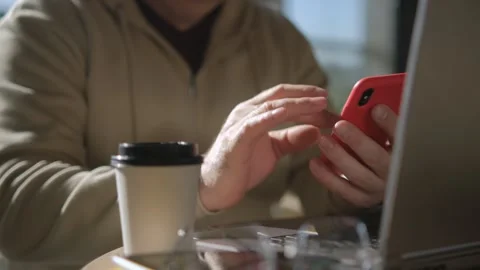 Side view. Hand of man using texting mobile phone or chat in cafe morning and Stock Footage 253239318