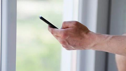 Side view. Hand of men using smartphone . Stock-Footage 129844968